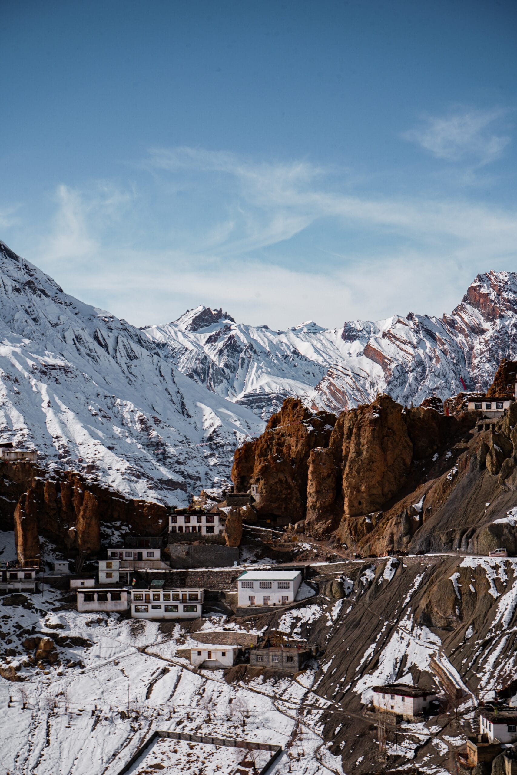 Vertical shot of a Dhankar monastery in Spiti Valley with snow-covered mountains in the background